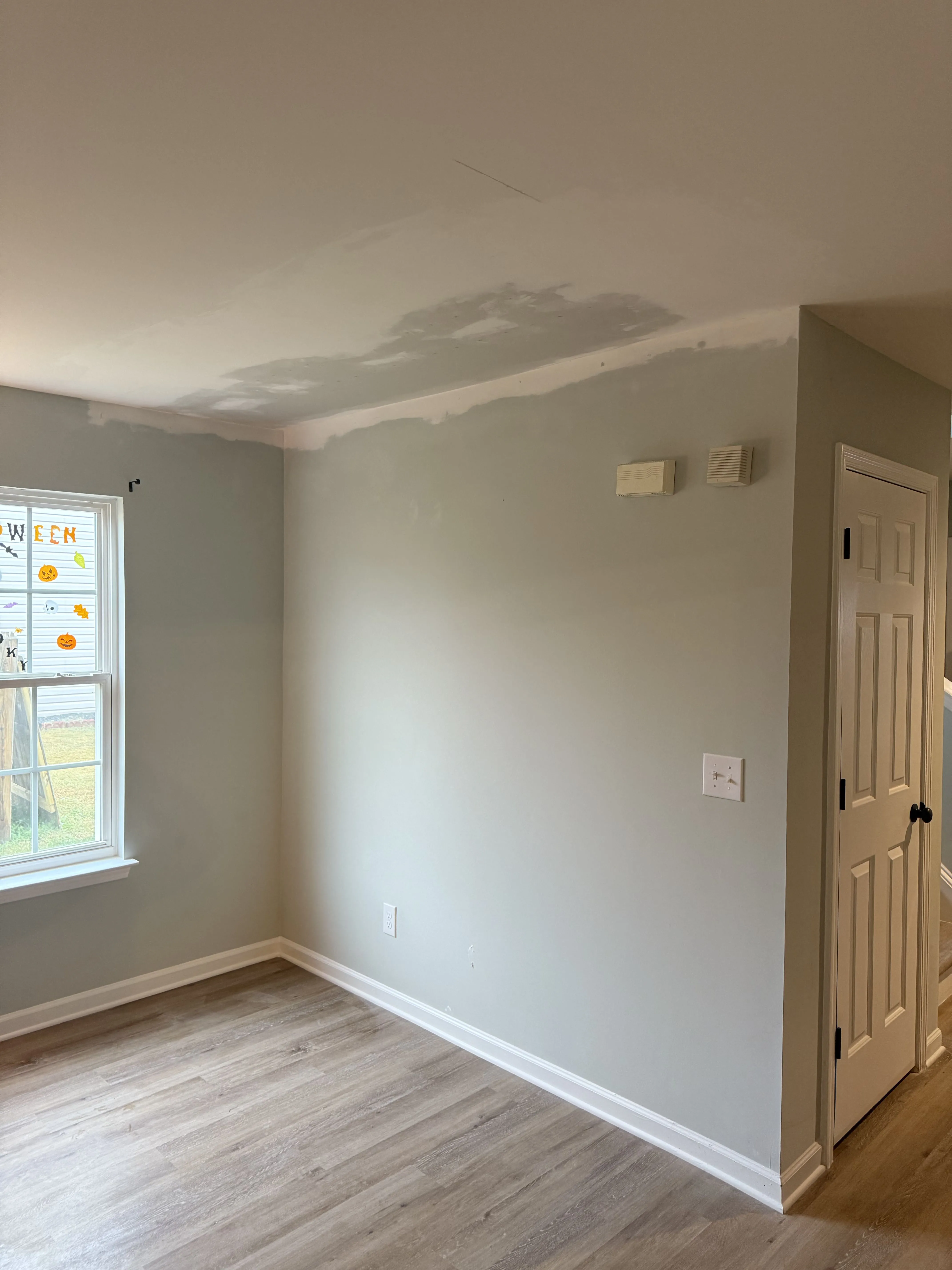 A freshly painted room with new flooring after a Carolina Pro Restoration rebuild